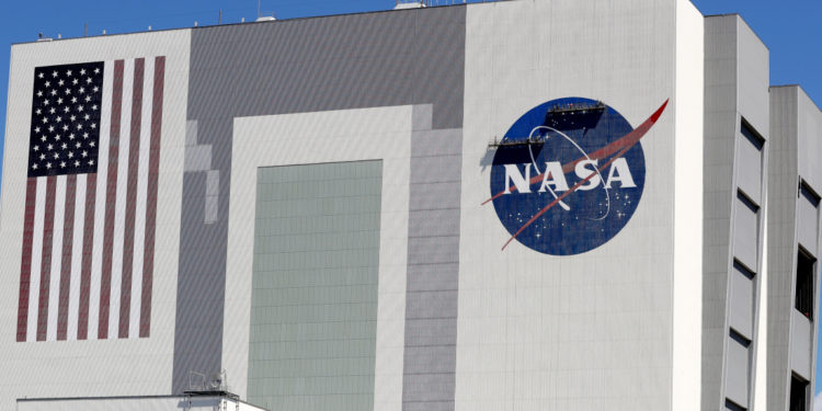 Workers near the top of the 526 ft. Vehicle Assembly Building at the Kennedy Space Center spruce up the NASA logo standing on scaffolds in Cape Canaveral, Fla., Wednesday, May 20, 2020. A SpaceX Falcon 9 rocket scheduled for May 27 will launch a Crew Dragon spacecraft on its first test flight with astronauts on-board to the International Space Station. (AP Photo/John Raoux)