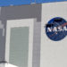 Workers near the top of the 526 ft. Vehicle Assembly Building at the Kennedy Space Center spruce up the NASA logo standing on scaffolds in Cape Canaveral, Fla., Wednesday, May 20, 2020. A SpaceX Falcon 9 rocket scheduled for May 27 will launch a Crew Dragon spacecraft on its first test flight with astronauts on-board to the International Space Station. (AP Photo/John Raoux)