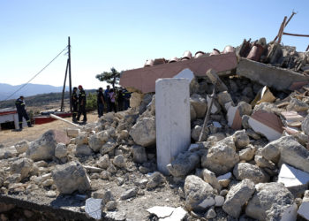 Firefighters stand next to a demolished Greek Orthodox church of Profitis Ilias after a strong earthquake in Arkalochori village on the southern island of Crete, Greece, Monday, Sept. 27, 2021. A strong earthquake with a preliminary magnitude of 5.8 has struck the southern Greek island of Crete, and Greek authorities say one person has been killed and several more have been injured. (AP Photo/Harry Nikos)