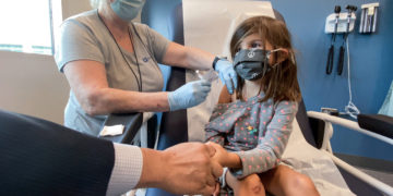 Bridgette Melo, 5, holds onto the hand of her dad Jim Melo as she gets the first of two Pfizer COVID vaccinations on September 28, 2021 during a clinical trial for children at Duke Health.
Shawn Rocco/Duke Health
Photos provided by Duke Health. Permission for CNN to use across all platforms and distribute to affils.