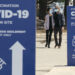 A couple leaves a COVID-19 vaccination clinic in Montreal, on Tuesday, March 23, 2021. THE CANADIAN PRESS/Paul Chiasson