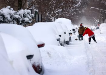 CHICAGO, ILLINOIS - FEBRUARY 16: People work to dig out their car along a residential street on February 16, 2021 in Chicago, Illinois. Chicago residents are digging out this morning after a snowstorm coupled with lake-effect snow dumped more than 17 inches of snow in some areas of the city since yesterday.   Scott Olson/Getty Images/AFP (Photo by SCOTT OLSON / GETTY IMAGES NORTH AMERICA / AFP)