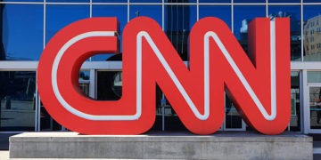 Atlanta, USA - October 19, 2011: Located in downtown Atlanta, Georgia next to Centennial Olympic Park, the CNN Center is the world headquarters of the Cable News Network (CNN). The building houses several newsrooms and studios for CNN's news channels along with this large CNN logo.