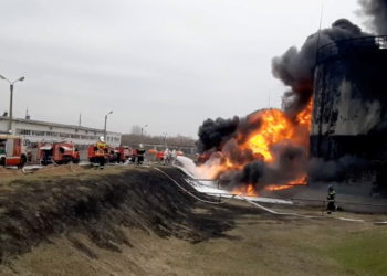 A still image taken from video footage shows members of the Russian Emergencies Ministry extinguishing a fire at a fuel depot in the city of Belgorod, Russia April 1, 2022. Russian Emergencies Ministry/Handout via REUTERS ATTENTION EDITORS - THIS IMAGE HAS BEEN SUPPLIED BY A THIRD PARTY. NO RESALES. NO ARCHIVES. MANDATORY CREDIT.