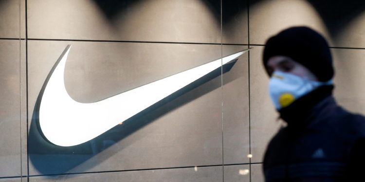 A man wearing a protective face mask amid the outbreak of the coronavirus disease (COVID-19) walks past a Nike brand store in central Kyiv, Ukraine December 10, 2020. REUTERS/Valentyn Ogirenko