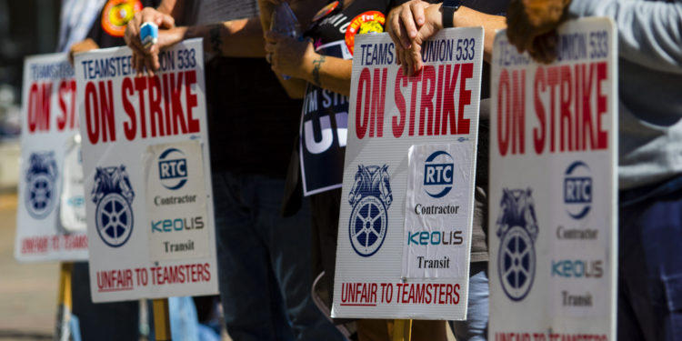 RENO, NEVADA, UNITED STATES - 2021/10/16: Union members on strike holding placards expressing their opinion at a march.
Union members and community members march in protest against Keolis management (multinational transportation company that operates public transport systems) after bus riders faced with disruptive new schedule. Local teamsters 533 remains on strike after negotiations failed. (Photo by Ty O'Neil/SOPA Images/LightRocket via Getty Images)