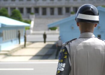 South Korean Soldier stands guard on the DMZ, North Korea is in the background