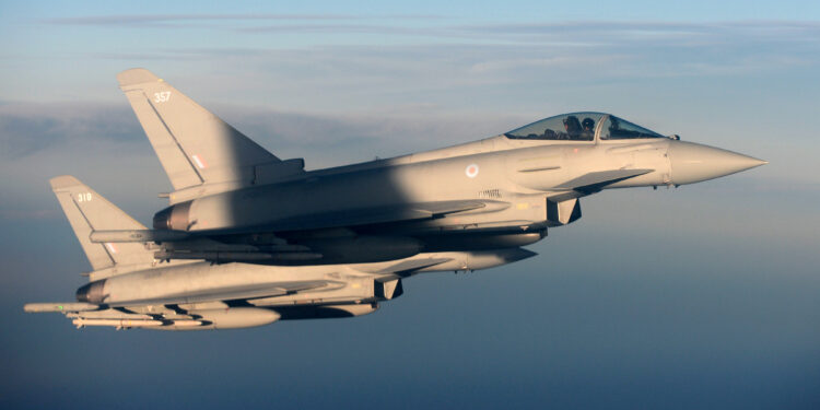 FILE PHOTO: British Royal Air Force's Typhoon Eurofighter jets demonstrate the interception of a Belgian air force transport plane as they fly over Britain, January 14, 2020. Picture taken January 14, 2020. REUTERS/Johanna Geron/File Photo